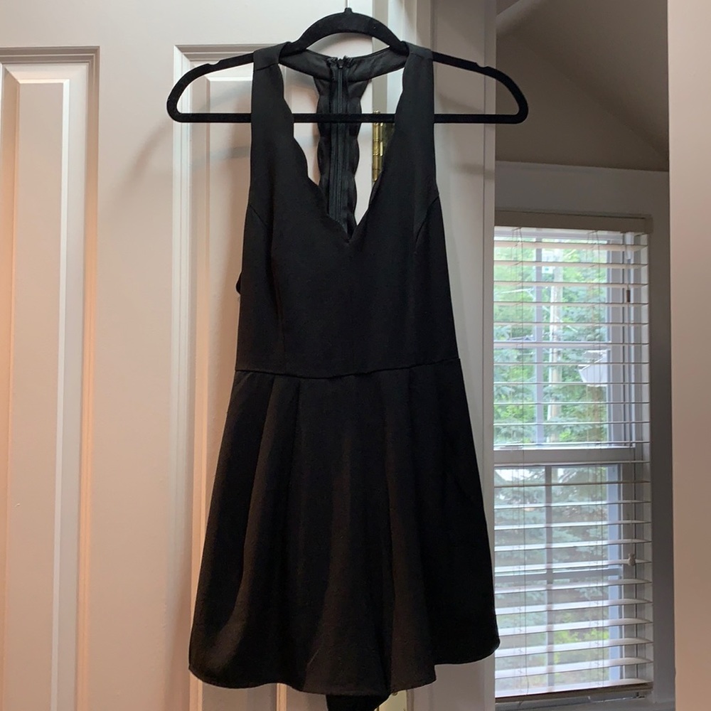 Lush black romper with adorable scalloped detail